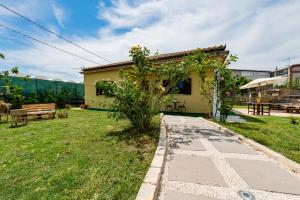 a small house with a garden and a walkway at GuestHost - Barni House in Montesilvano