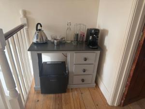a table with a coffee maker on top of it at Charming Town House Central Margate in Margate +16 photos