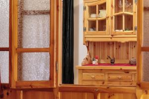 a kitchen with a wooden cabinet and a sink at Petit Logement Cerise L'écrin d'Ari in Cerise +22 photos
