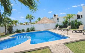 a swimming pool in the backyard of a house at La Casa del Cenote in Playa del Carmen