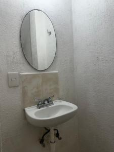 a bathroom with a sink and a mirror on the wall at La Casa del Cenote in Playa del Carmen +6 photos