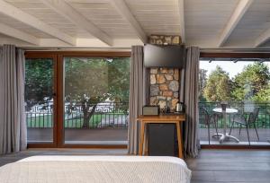 a bedroom with a bed and a large sliding glass door at Ktima Faki, The One & Only Destination on Mount Olympus in Litochoro +280 photos