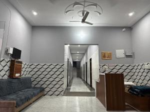 a living room with a couch and a ceiling fan at RADHA DEVI GUEST HOUSe in Juliāsar