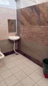 a bathroom with a sink and a toilet at RADHA DEVI GUEST HOUSe in Juliāsar