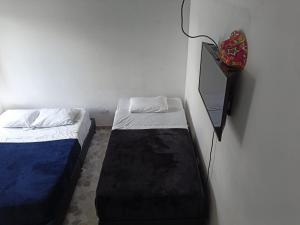 a room with two beds and a mirror on the wall at Hotel campestre terrazas y sol in La Vega