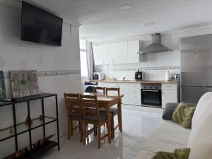 a kitchen with a table and chairs in a room at La Cantora in Sagunto +9 photos
