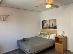 a bedroom with a bed and a ceiling fan at La Cantora in Sagunto
