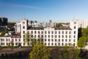 ein großes weißes Gebäude mit vielen Fenstern in der Unterkunft Focus Hotel Łódź in Łódź