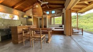 a kitchen and dining room with a table and chairs at 月みるいえ in Akaoki +36 photos
