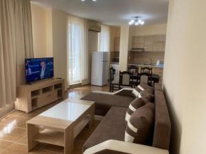 a living room with a couch and a tv and a kitchen at goldenseaview apartment 2 in Pomorie