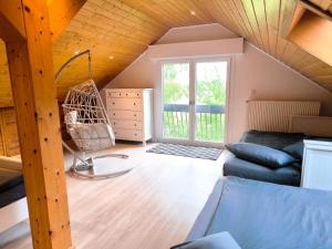 a living room with a couch and a swing at Ferienwohnung am Soonwald in Ellern