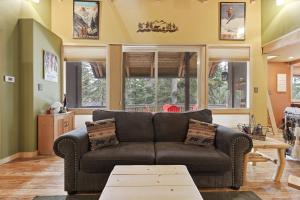 a living room with a couch and a table at A-Frame Home with Deck & BBQ - VH223 cabin in Bear Valley