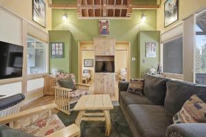 a living room with a couch and a table at A-Frame Home with Deck & BBQ - VH223 cabin in Bear Valley