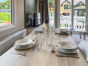 a dining room table with plates and glasses on it at Forest Sherman - Uk50089 in Durham