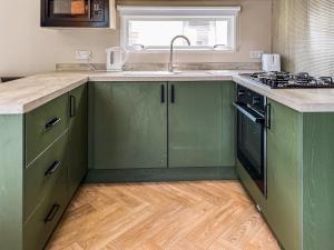 a kitchen with green cabinets and a sink at Forest Sherman - Uk50089 in Durham
