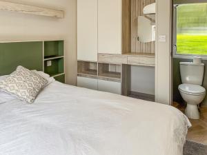 a bedroom with a white bed and a toilet at Forest Sherman - Uk50089 in Durham +8 photos