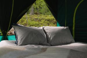 two pillows on a bed in a tent at Experience Finland Like a Finn-Private Island Tampere Region in Orivesi