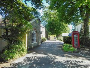 a street with a red phone booth and a house at Oak Lodge - Uk49400 in Pembrokeshire