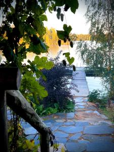 a stone walkway next to a body of water at Experience Finland Like a Finn-Private Island Tampere Region in Orivesi