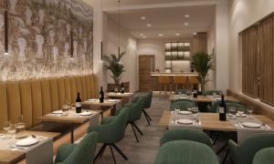 a restaurant with wooden tables and green chairs at PFA Hotel - Viareggio in Viareggio