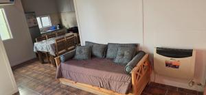 a bedroom with a wooden bed with pillows on it at NEUQUEN alojamiento in Neuquén