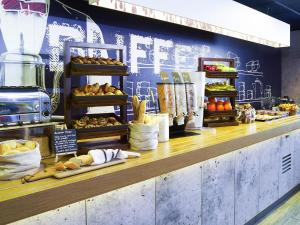 a bakery with a counter with bread and other foods at ibis budget Birmingham Centre in Birmingham