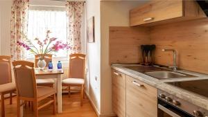 a kitchen with a sink and a table with chairs at Ferienwohnung Daun in Daun