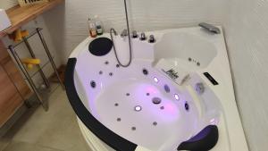 a bathroom with a bath tub with a sink at Ferienwohnung Daun in Daun +37 photos
