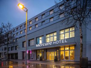 a large building with a light pole in front of it at Hotel Mercure Graz City in Graz +114 photos