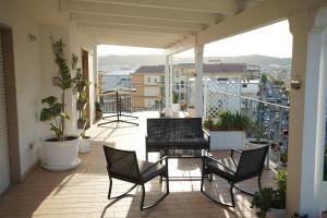 a balcony with chairs and a table on a balcony at TROPICAL ROOMS Vista Mare in Cirò Marina