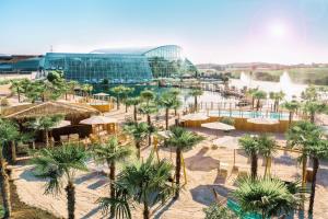a view of a resort with palm trees and a building at Hotel Sonne in Sinsheim