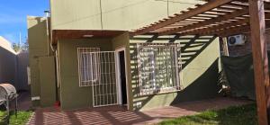 a building with a gate and a door with a fence at NEUQUEN alojamiento in Neuquén +10 photos