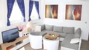 a living room with a couch and a tv at Ferienwohnung Vulkaneifel in Daun