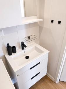 a white bathroom with a sink and a shower at Domeček u Prahy in Nupaky +27 photos