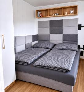 a bed with two pillows on it in a room at Domeček u Prahy in Nupaky