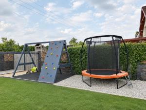 a playground with a climbing frame and a slide at Domeček u Prahy in Nupaky