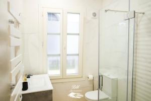 a bathroom with a toilet and a glass shower at BM Apartamentos in Ribadesella +14 photos