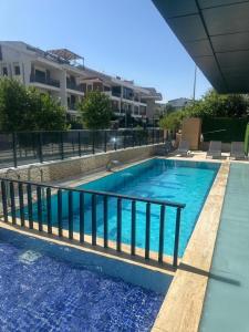 a swimming pool with a fence around it at Fırat Otel in Marmaris