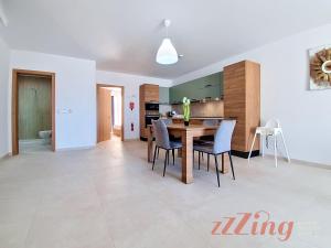 a kitchen and dining room with a table and chairs at Merhba Court Apartments - St Pauls Bay in St. Paul's Bay +33 photos