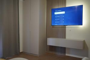 a flat screen tv hanging on a wall at TROPICAL ROOMS Vista Mare in Cirò Marina +47 photos