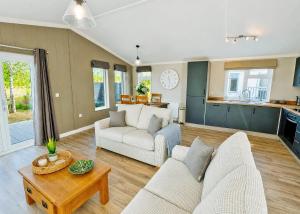 a living room with a couch and a table at Bosworth Lakeside Lodges in Carlton