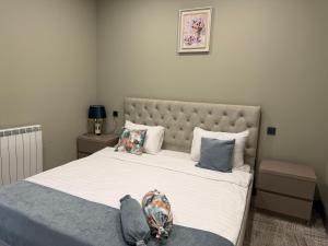 a bedroom with a large bed with white sheets and pillows at Aurora Hotel Batumi in Batumi +17 photos