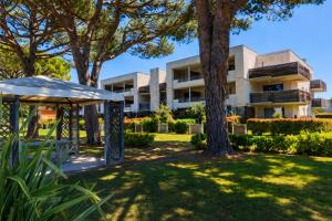 an apartment building with trees in front of it at Carre Marine N12 - 2P4 in Mandelieu-La Napoule