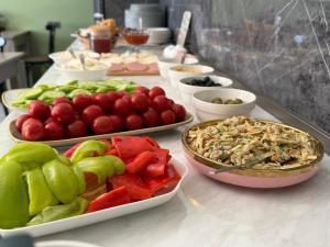 a buffet with plates of food on a table at Aurora Hotel Batumi in Batumi