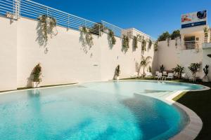 a large swimming pool in the middle of a building at ARBORIS BELLI Hotel in Alberobello