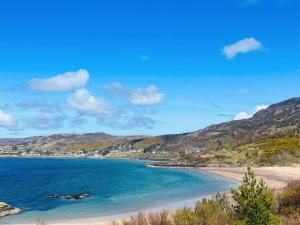 a view of a beach with mountains in the background at Bramble Cottage in Gairloch