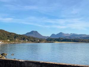 a view of a lake with mountains in the background at Bramble Cottage in Gairloch +26 photos