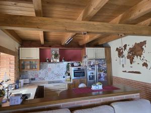 a kitchen with wooden ceilings and a table in a room at Las Fonderas in Cuadros