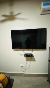 a flat screen tv hanging on a wall at Simon donkor 2 in Kumasi