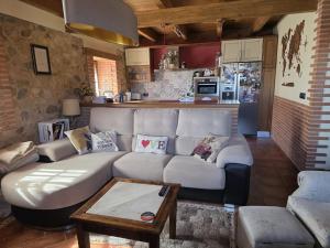 a living room with a white couch and a kitchen at Las Fonderas in Cuadros +14 photos